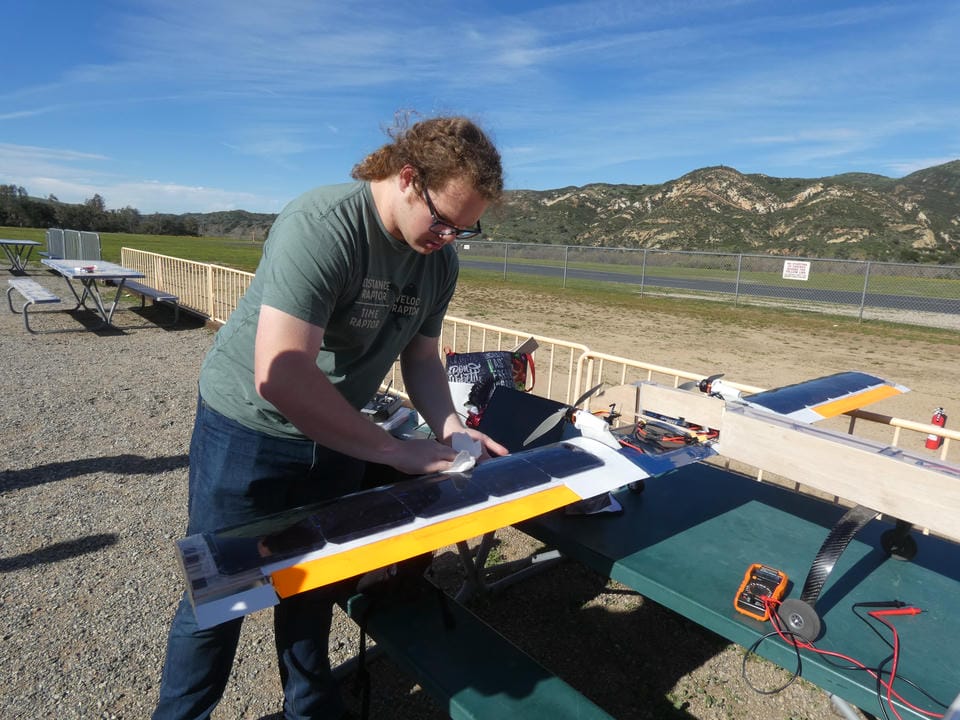 Team member cleaning the solar airplane panels