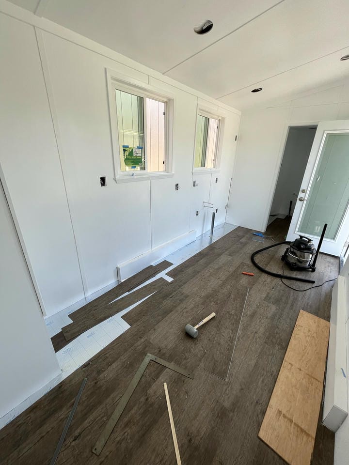 The flooring is being installed, and some peices are still missing.