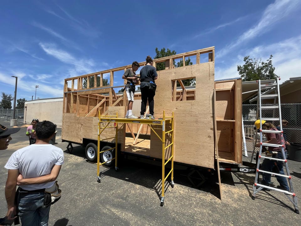 Front view of the tiny house frame with sheeting being added.